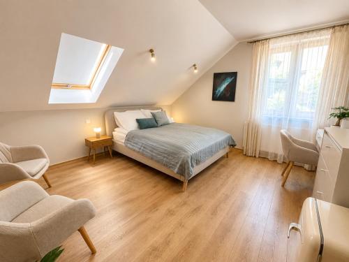 a bedroom with a bed and a skylight at Młyn Bosaka in Ojców