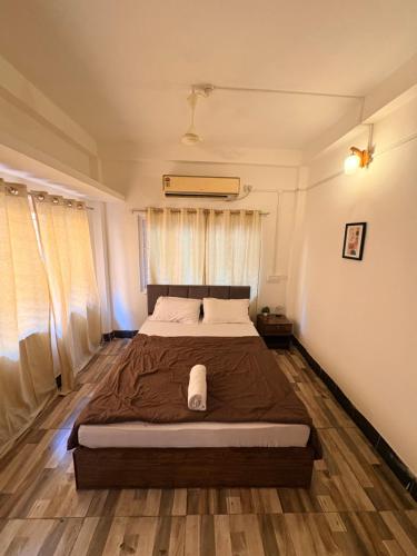 a bedroom with a large bed in front of a window at Heritage Home in Guwahati