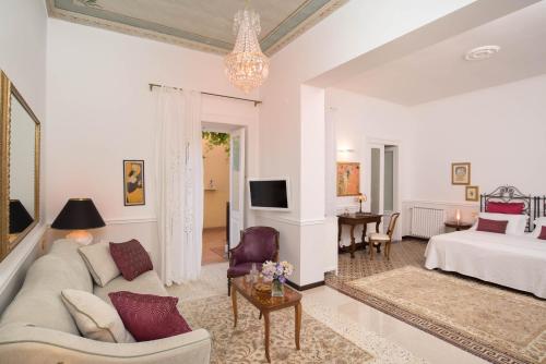 a living room with a couch and a bed at Romantic Hotel & Restaurant Villa Cheta Elite in Maratea