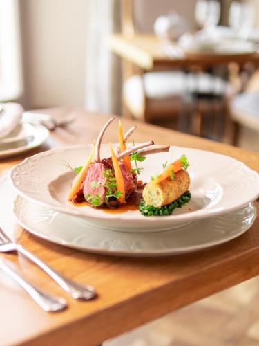 a white plate of food on a table at Chateau Mcely in Mcely