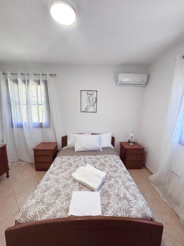 a bedroom with a bed with two towels on it at Ocean Peak Villa in Kalymnos