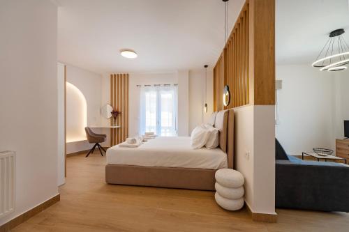 a bedroom with a bed and a blue couch at Elysian suite in Parga