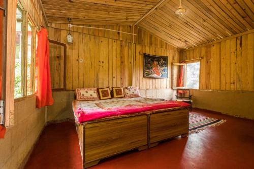 a bedroom with a bed in a wooden room at Rishikesh Valley in Rishīkesh