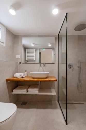 a bathroom with a sink and a shower at Elysian suite in Parga