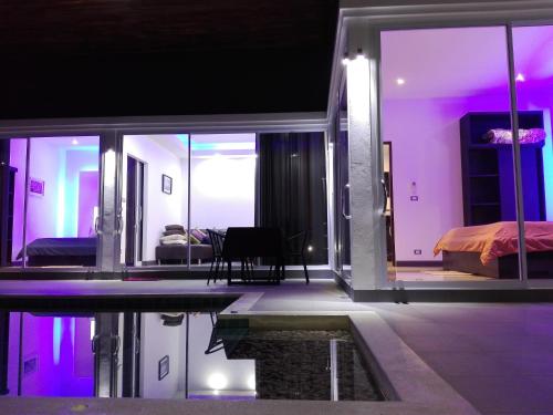 a room with a swimming pool and a bedroom at Rocking Chair Pool Villa in Chaweng