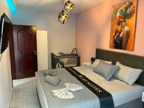 a bedroom with a large bed with a robe on it at Annaria in Leptokarya