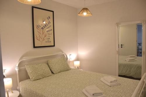 a small bedroom with a bed and a mirror at Samothrakis Michelangelo 401 in Samothraki
