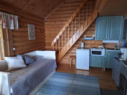 a bedroom with a bed in a wooden room at Honkala Cottage in Keyritty