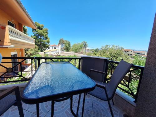 a table and two chairs on a balcony at Stella Maris sea front studios in Kanatádhika