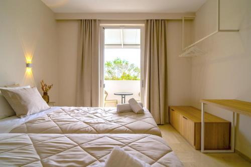 a hotel room with a large bed and a window at Zante Apts in Laganas