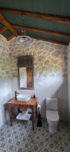 a bathroom with a sink and a toilet at Casas Rurales Cortijos el Encinar in Torres