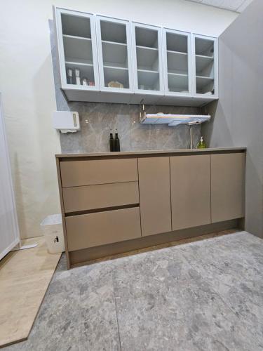 a kitchen with a sink and white cabinets at T hotel in Seoul