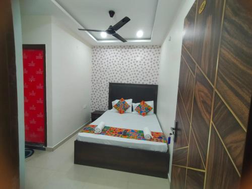 a bedroom with a bed and a ceiling fan at Hotel Tirumala Vaibhav in Secunderabad