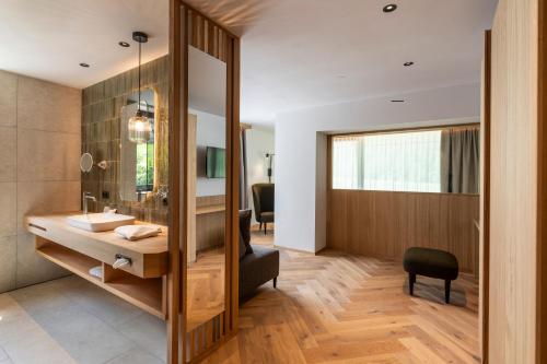 a bathroom with a sink and a mirror at Hotel Gampen in Solda