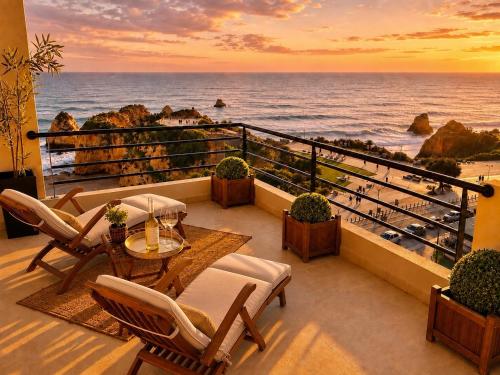 a balcony with a view of the ocean at sunset at MyOcean Luxury l Huge Panoramic Sea View Balcony & Private Garage in Portimão
