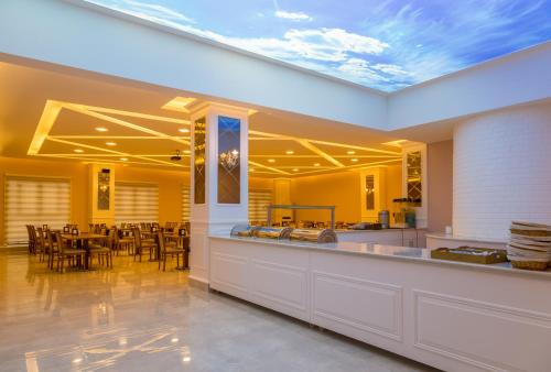 a dining room with yellow walls and a ceiling at Bursa Palas Hotel in Bursa