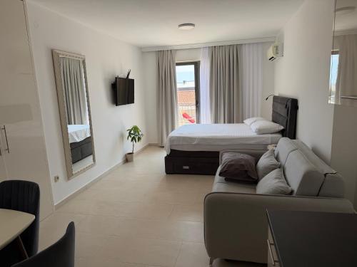 a living room with a bed and a couch at Apartments Petar in Budva