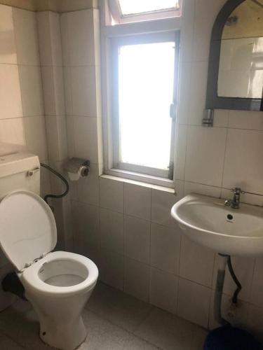 a bathroom with a toilet and a sink at Fun Viewpoint Homestay Darjeeling in Darjeeling