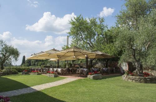 a catering tent in a park with tables and chairs at Hotel Belvedere Di San Leonino in Castellina in Chianti