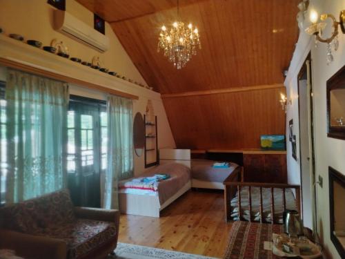 a living room with a bed and a couch at Mahmud Guest House in Sheki