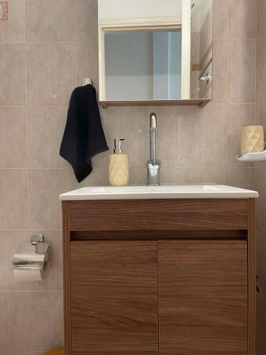 a bathroom with a sink and a mirror at Noēma House II in Samos