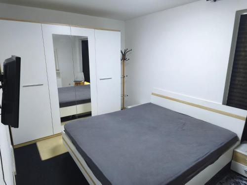 a bedroom with a bed and a mirror at Bochum Wohnung in Bochum
