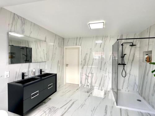 a bathroom with a black sink and a shower at Modern Country House in Merzig