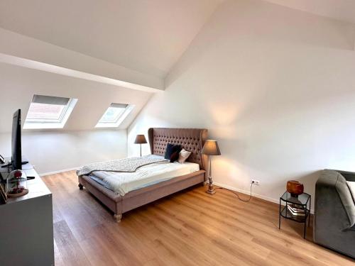 a bedroom with a bed and a flat screen tv at Modern Country House in Merzig