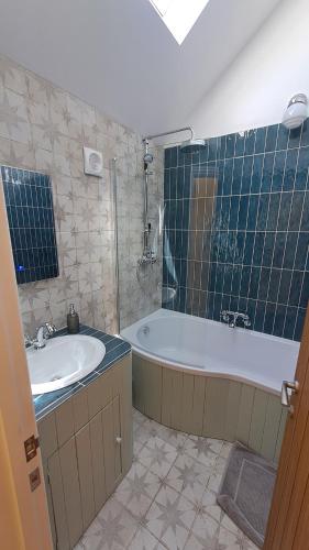 a bathroom with a tub and a sink at Valley View Haven in Kingsbridge