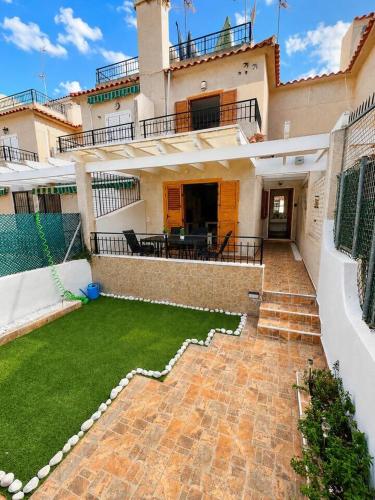 a house with a patio and a grass yard at Villa Belén . in El Moncayo