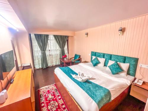 a bedroom with a large bed and a window at Rare Himalayas Mansarovar in Darjeeling