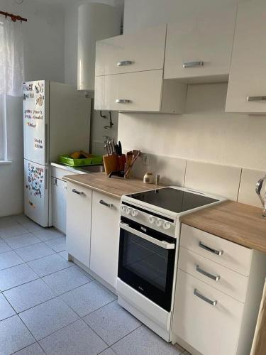a kitchen with white cabinets and a stove top oven at HOSTEL Simply Great in Toruń