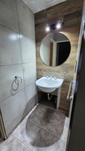 a bathroom with a sink and a mirror at PM departamentos in San Rafael