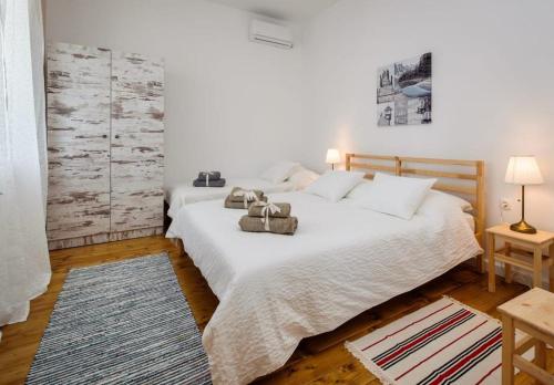 a bedroom with two beds with towels on the bed at Luxury Beachfront Villa Kata in Rogotin