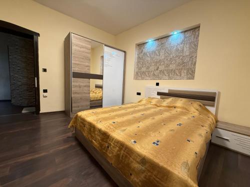 a bedroom with a large bed and a mirror at Етаж от къща в Разград in Razgrad