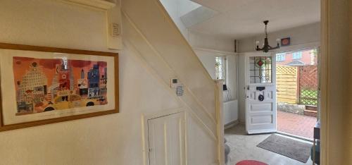a hallway with a painting on the wall and a door at Gateway to Gower in Dunvant