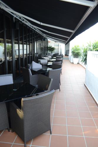 a row of tables and chairs on a patio at The Sterling Boutique Hotel Melaka in Melaka