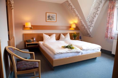 Landhotel Weining في Breitenbach: غرفه فندقيه بسرير وكرسي