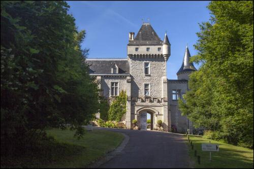 a castle with a tower on the side of a road at CHATEAU DE LA RIVIERE in La Rivière