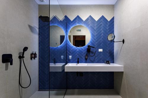 a bathroom with a sink and a mirror at Oysters & Bubbles Gastro Hotel. Rynok square in Lviv