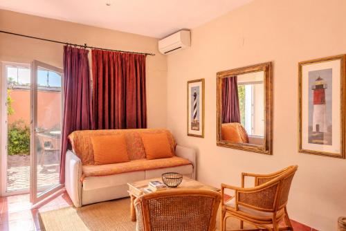 a living room with a couch and a table at Hotel Madreselva - Grupo Califa in Los Caños de Meca
