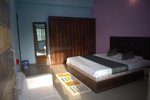 a bedroom with a king sized bed and a window at Hotel Harsh Garden in Varanasi