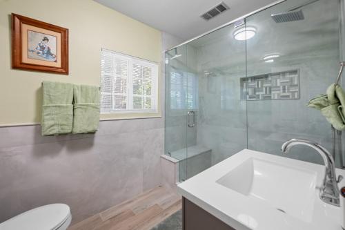a bathroom with a toilet and a sink and a shower at Jade Bear Retreat in Big Bear City