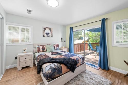 a bedroom with a bed and a sliding glass door at Jade Bear Retreat in Big Bear City