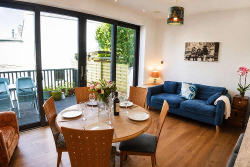 a living room with a table and a blue couch at Spacious Pretty home in Old Totterdown in Bristol