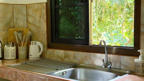 a kitchen counter with a sink and a window at Zen Trinity House in Ko Phangan