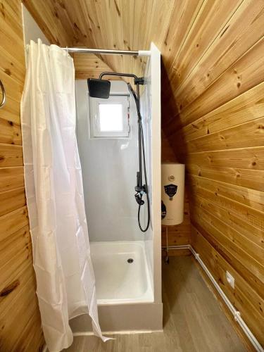 a bathroom with a shower with a shower curtain at Beshik Guest House in Bokonbayevo