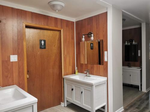 a bathroom with a white sink and a mirror at EcoSun Hostel in Montague