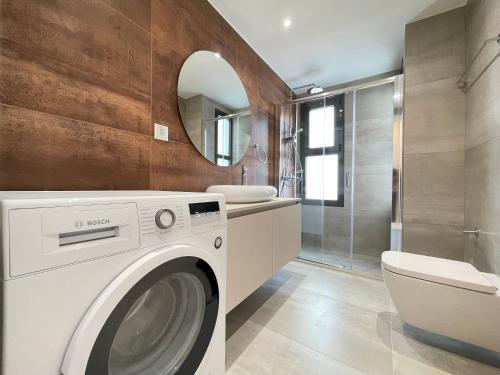 a bathroom with a washing machine and a sink at Athenean Oasis in Ellinikon in Athens
