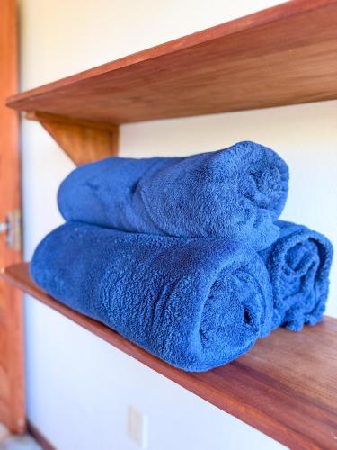 a pile of blue towels sitting on a shelf at Casa Magna in Itacaré